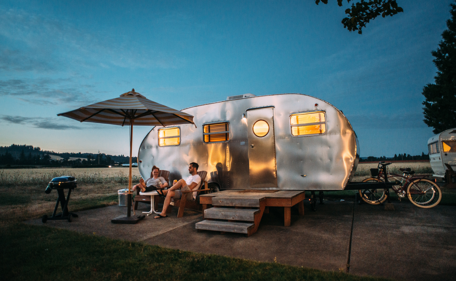 People sitting outside a trailer