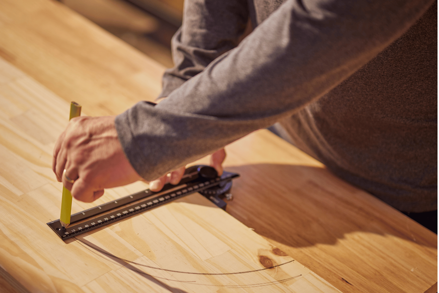 Man using tool to measure wood
