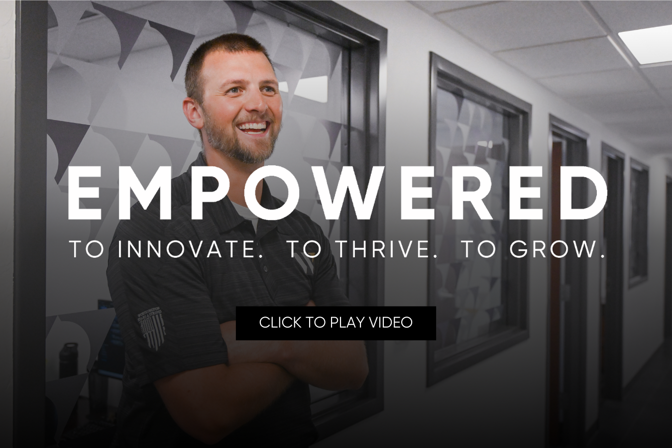 Man smiling with arms crossed.