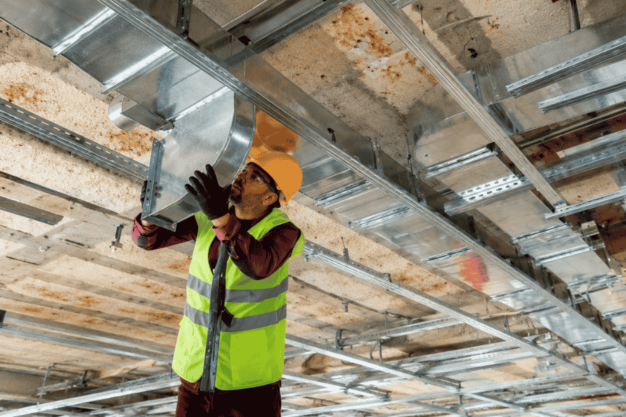 Man installing HVAC ducts