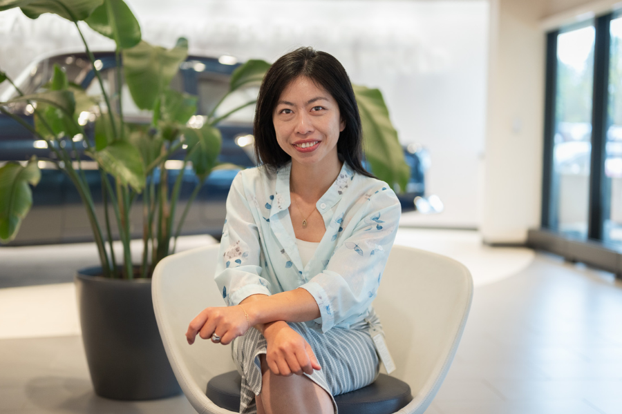 female employee sitting in office chair smiling