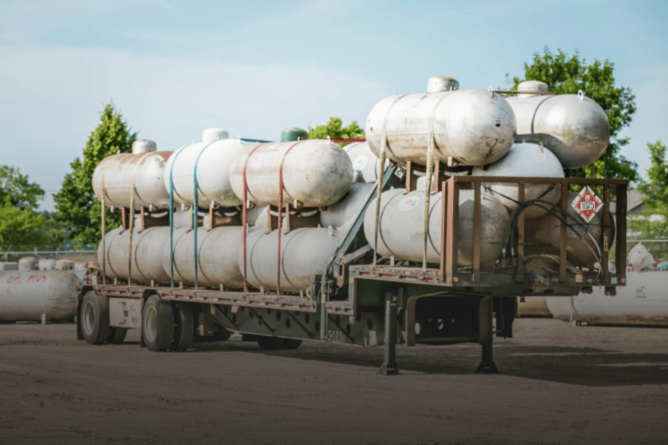truckload of old large tanks